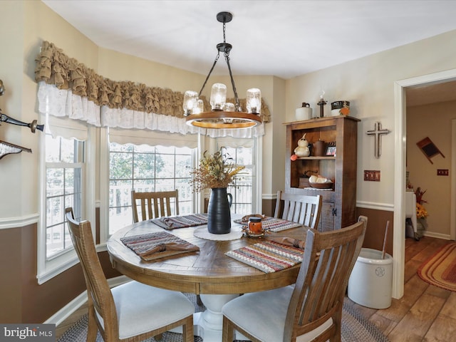 dining space featuring hardwood / wood-style floors and a notable chandelier