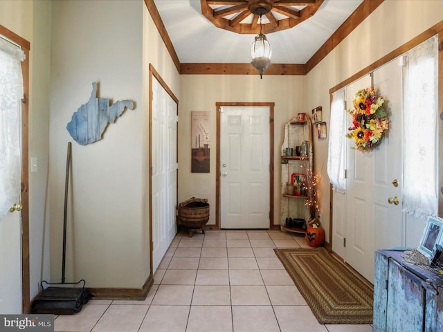 foyer with light tile patterned floors and ceiling fan