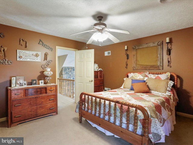 bedroom with a textured ceiling, light carpet, and ceiling fan