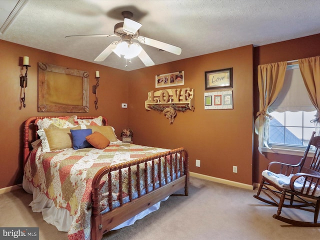 bedroom featuring carpet flooring, a textured ceiling, and ceiling fan