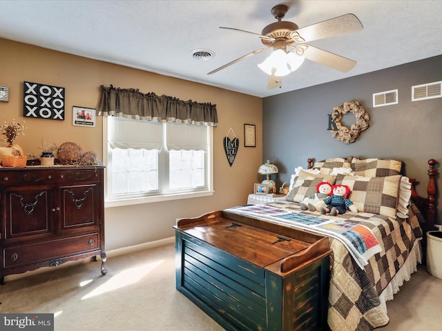 bedroom with ceiling fan and light carpet