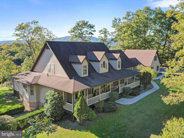 view of front of house with a front yard and covered porch