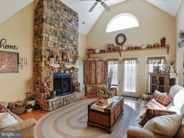 living room featuring high vaulted ceiling, plenty of natural light, light hardwood / wood-style floors, and ceiling fan