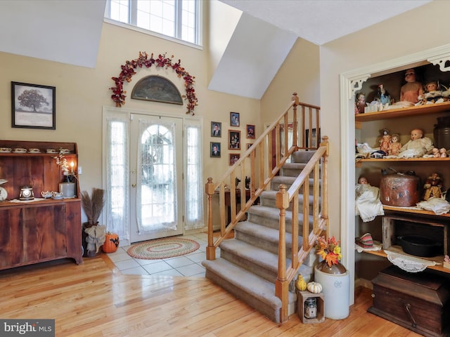 foyer entrance with light hardwood / wood-style floors and a healthy amount of sunlight