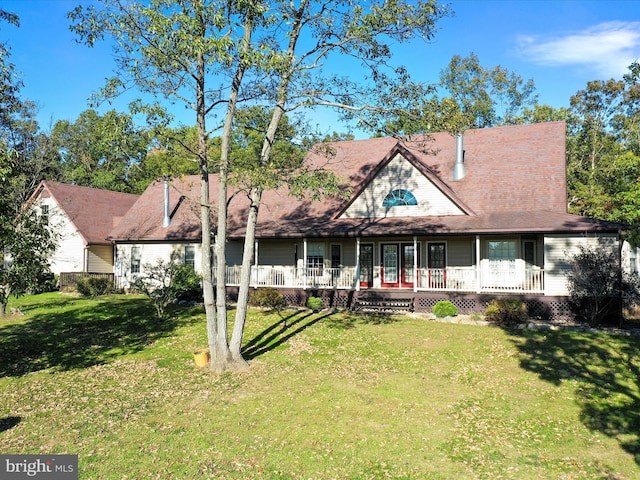 rear view of property featuring a lawn and a porch