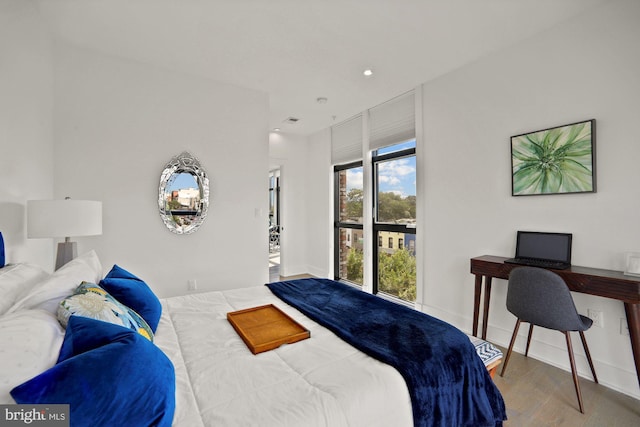 bedroom with hardwood / wood-style flooring