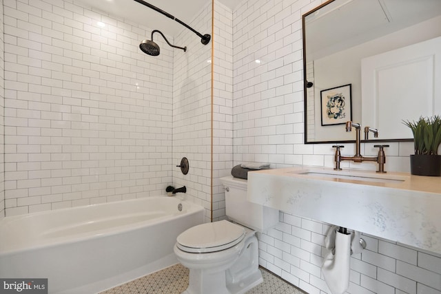 bathroom featuring tile walls, tiled shower / bath combo, toilet, and tile patterned flooring