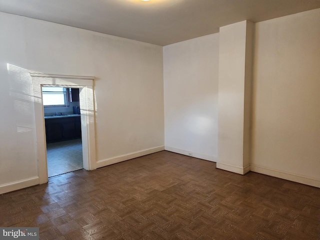 empty room with dark parquet flooring