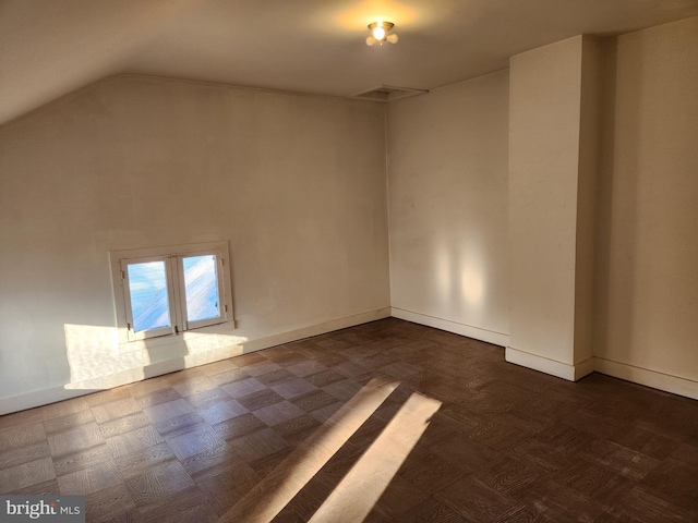 empty room with lofted ceiling