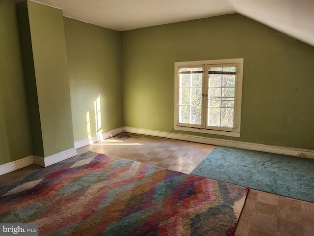 spare room with vaulted ceiling