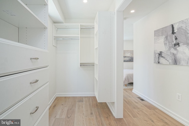 spacious closet featuring light hardwood / wood-style flooring