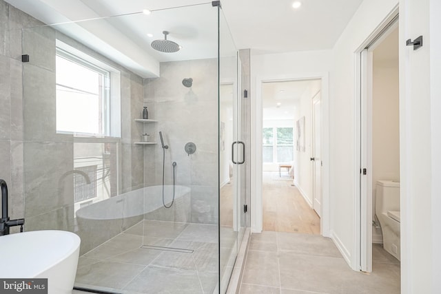 bathroom with toilet, tile patterned floors, and independent shower and bath