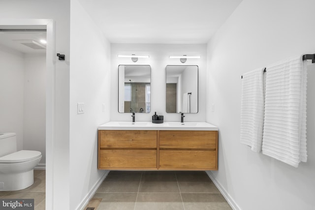 bathroom with vanity, toilet, and tile patterned flooring