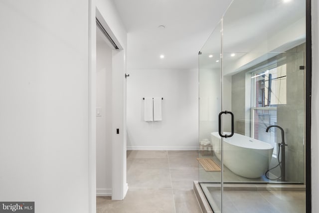 bathroom with a tub and tile patterned floors