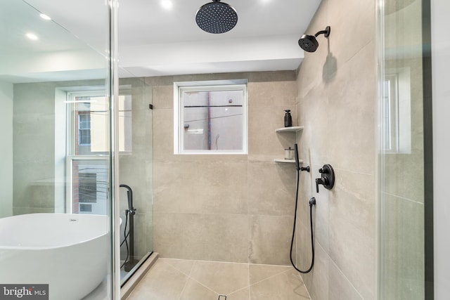 bathroom with a shower with shower door and tile patterned flooring