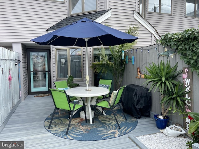 wooden deck featuring area for grilling