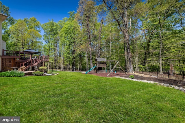 view of yard with a playground and a deck