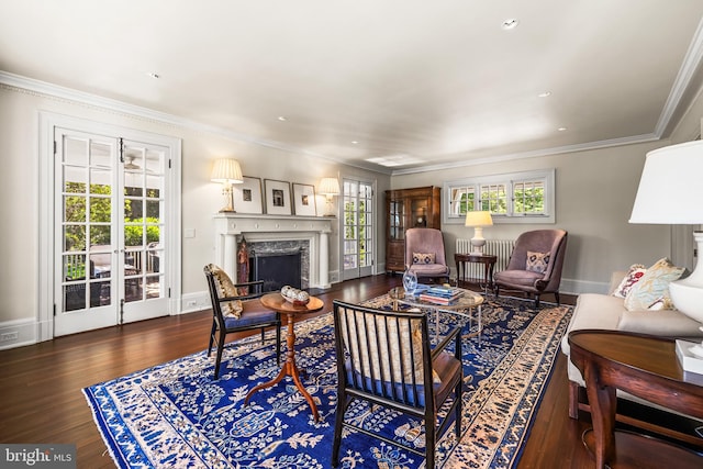 living room with a premium fireplace, dark wood-type flooring, and crown molding