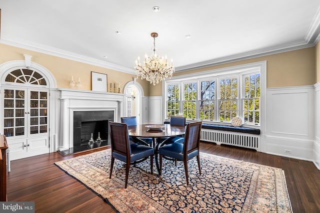 dining room featuring crown molding, radiator heating unit, a chandelier, and dark hardwood / wood-style flooring