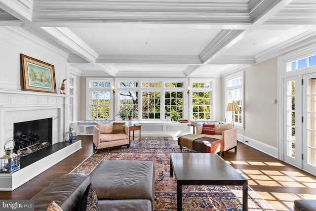 sunroom / solarium featuring a high end fireplace, a healthy amount of sunlight, beamed ceiling, and coffered ceiling