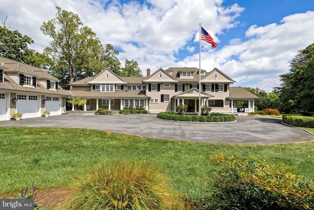 view of front of home featuring a garage and a front lawn