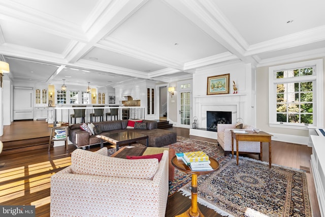 living room with beam ceiling, ornamental molding, hardwood / wood-style flooring, and coffered ceiling