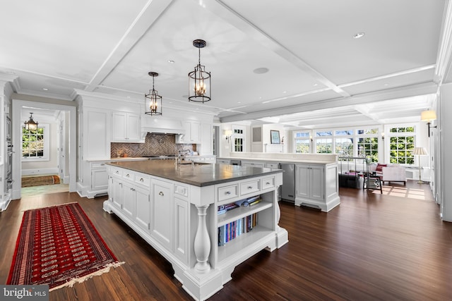 kitchen with white cabinetry, a kitchen island with sink, and dark wood-type flooring