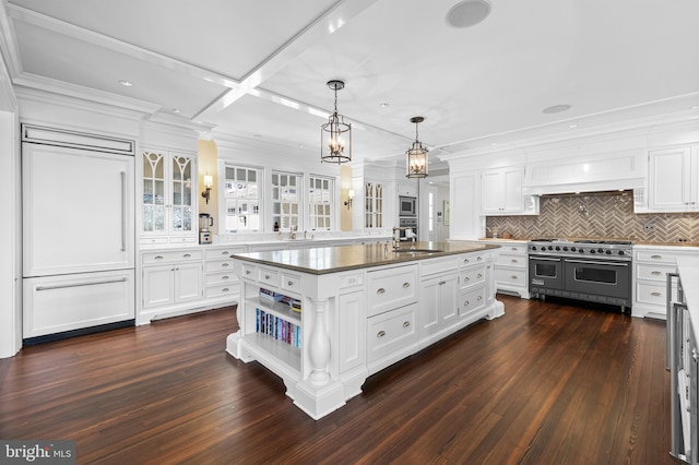 kitchen featuring white cabinetry, dark hardwood / wood-style floors, a kitchen island with sink, and stainless steel appliances