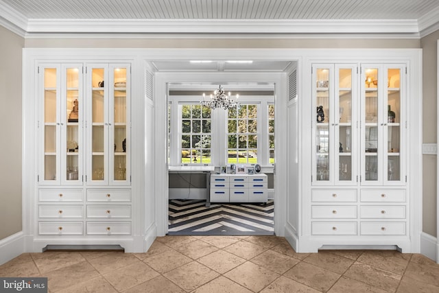 doorway to outside featuring crown molding, a notable chandelier, and light tile patterned floors