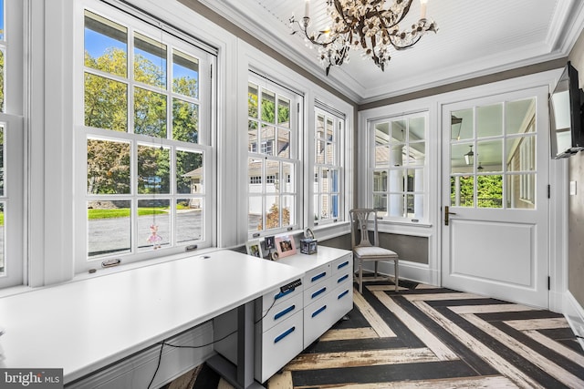 interior space featuring crown molding, dark parquet floors, and a chandelier