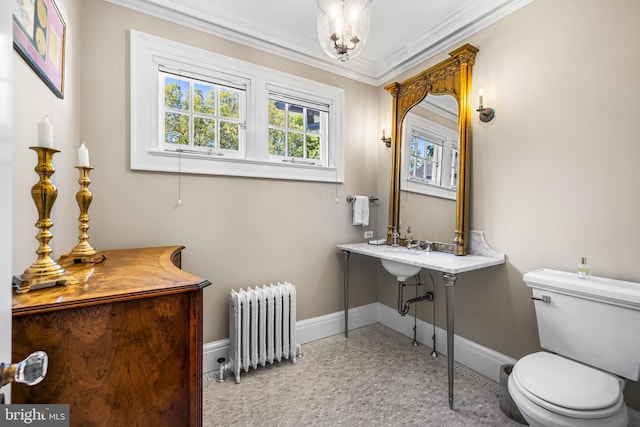 bathroom with toilet, radiator heating unit, and ornamental molding