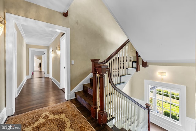 stairway featuring crown molding and wood-type flooring