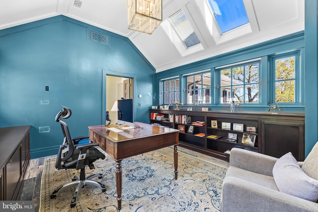 office space with crown molding, wood-type flooring, and vaulted ceiling with skylight