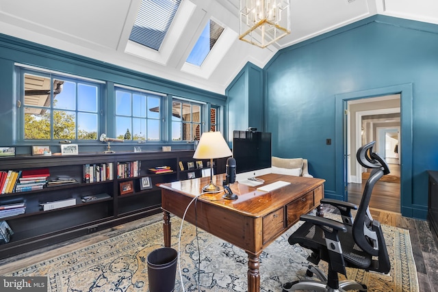 office area featuring lofted ceiling with skylight, crown molding, wood-type flooring, and an inviting chandelier