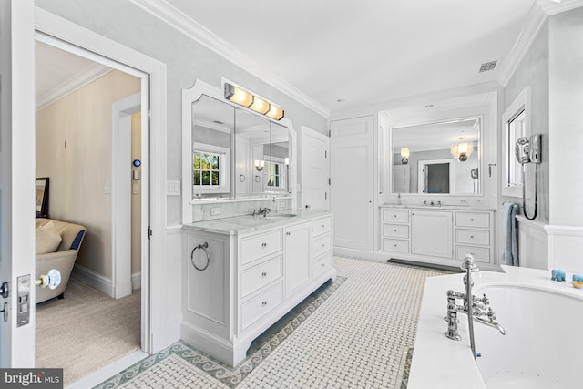 bathroom with vanity, crown molding, and a bathing tub