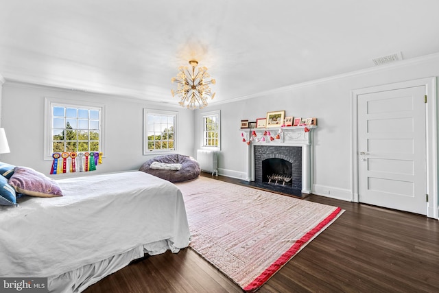 bedroom featuring radiator heating unit, ornamental molding, dark wood-type flooring, and a fireplace