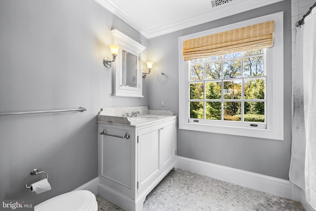 bathroom featuring a wealth of natural light, vanity, ornamental molding, and toilet