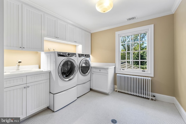 laundry area with sink, separate washer and dryer, radiator heating unit, crown molding, and cabinets