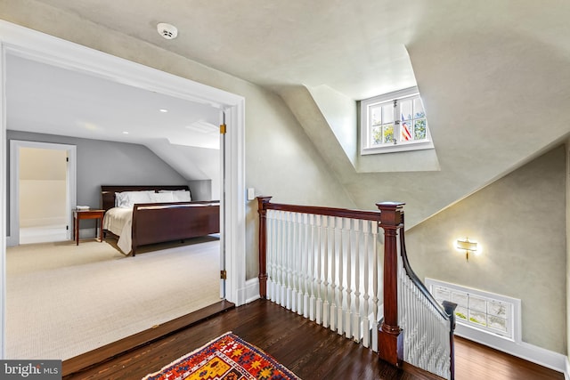 bedroom with dark wood-type flooring and lofted ceiling with skylight