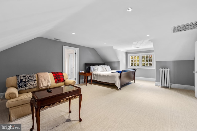 carpeted bedroom with vaulted ceiling and radiator heating unit