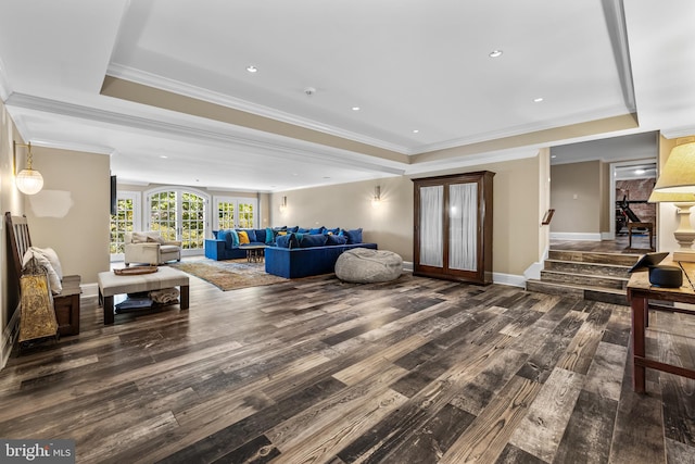 living room featuring ornamental molding, dark hardwood / wood-style floors, and a tray ceiling