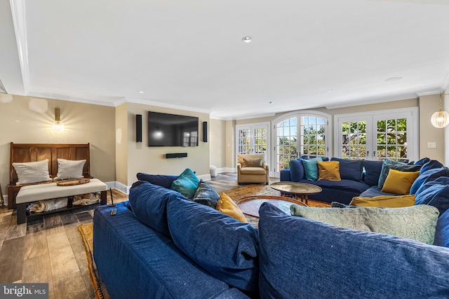 living room with french doors, hardwood / wood-style floors, and crown molding