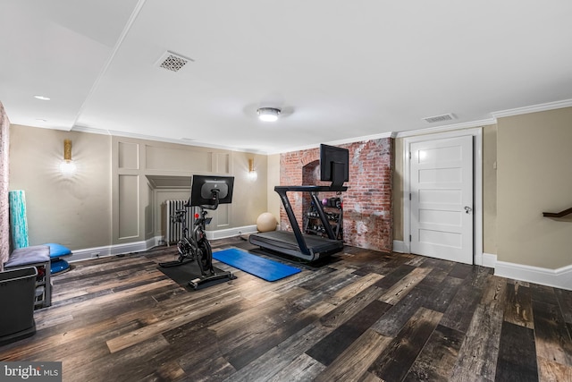 exercise room with crown molding and wood-type flooring