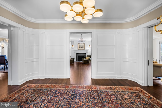 corridor featuring ornamental molding and dark hardwood / wood-style floors