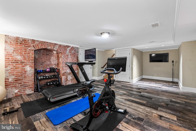 exercise area featuring crown molding and dark hardwood / wood-style floors