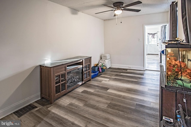 interior space featuring dark wood-type flooring and ceiling fan