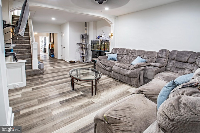 living room featuring hardwood / wood-style flooring and ceiling fan