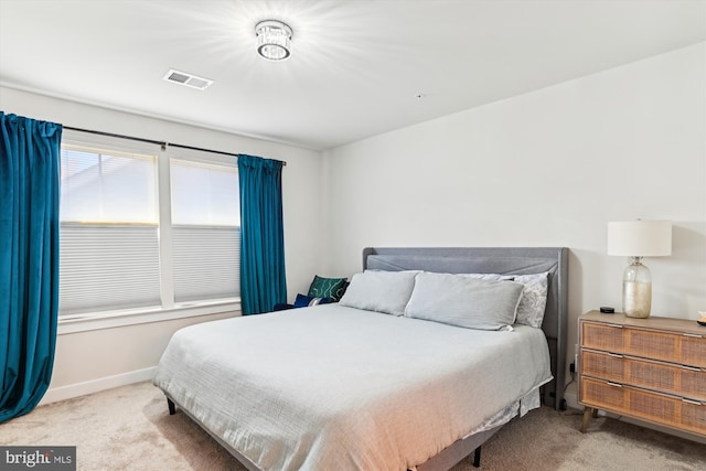 bedroom featuring light carpet