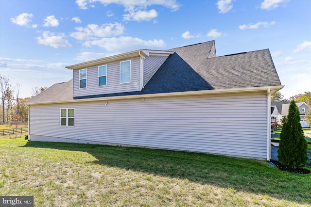 view of side of home featuring a yard