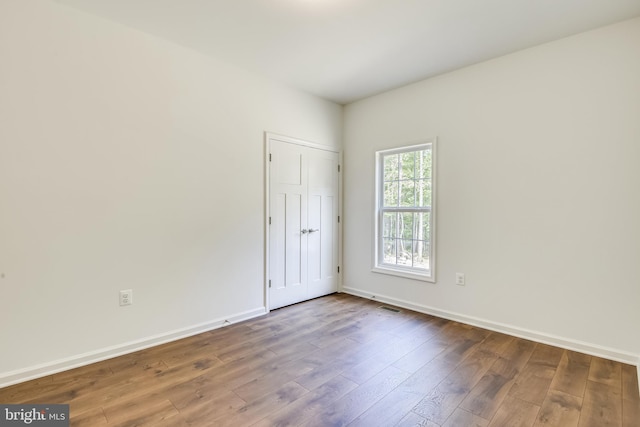 spare room with wood-type flooring